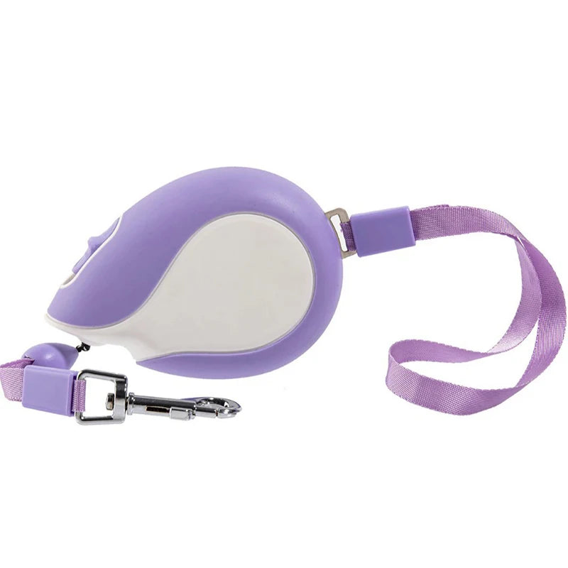 Purple retractable dog leash with webbing strap and metal clip, compact handheld housing